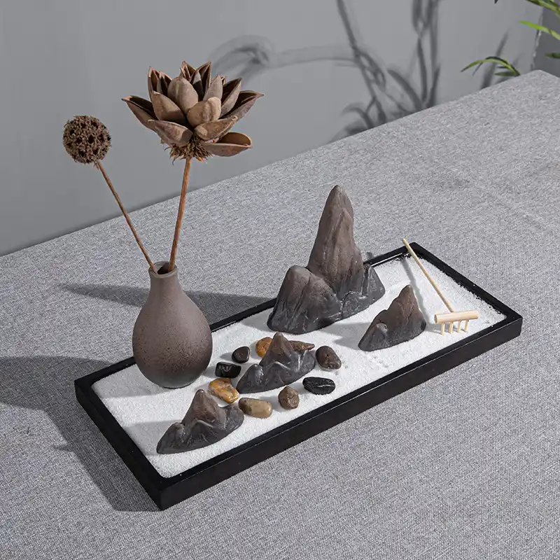 - Buddha Bodhis Raking sand in a mini zen garden for stress relief