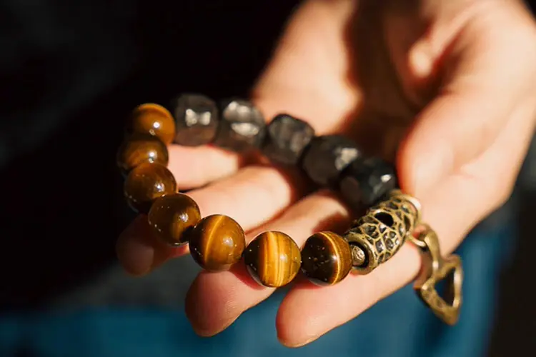 The Meaning of a Tiger Eye Bracelet: Understanding Its Benefits and How to Wear It 2 - Buddha Bodhis Tiger's Eye and Ebony Arrowhead Bracelet Grounded Action