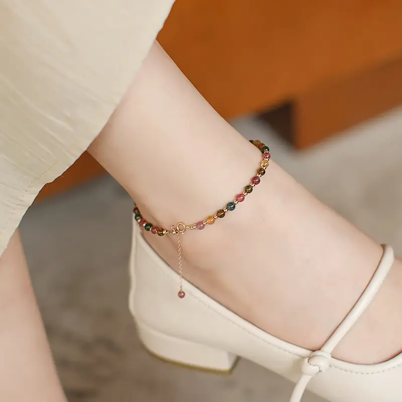 Handcrafted Aurora Crystal & Zircon Dainty Anklet | Grounding Charm for Radiant Energy - Buddha Bodhis Woman wearing crystal anklet for grounding on grass