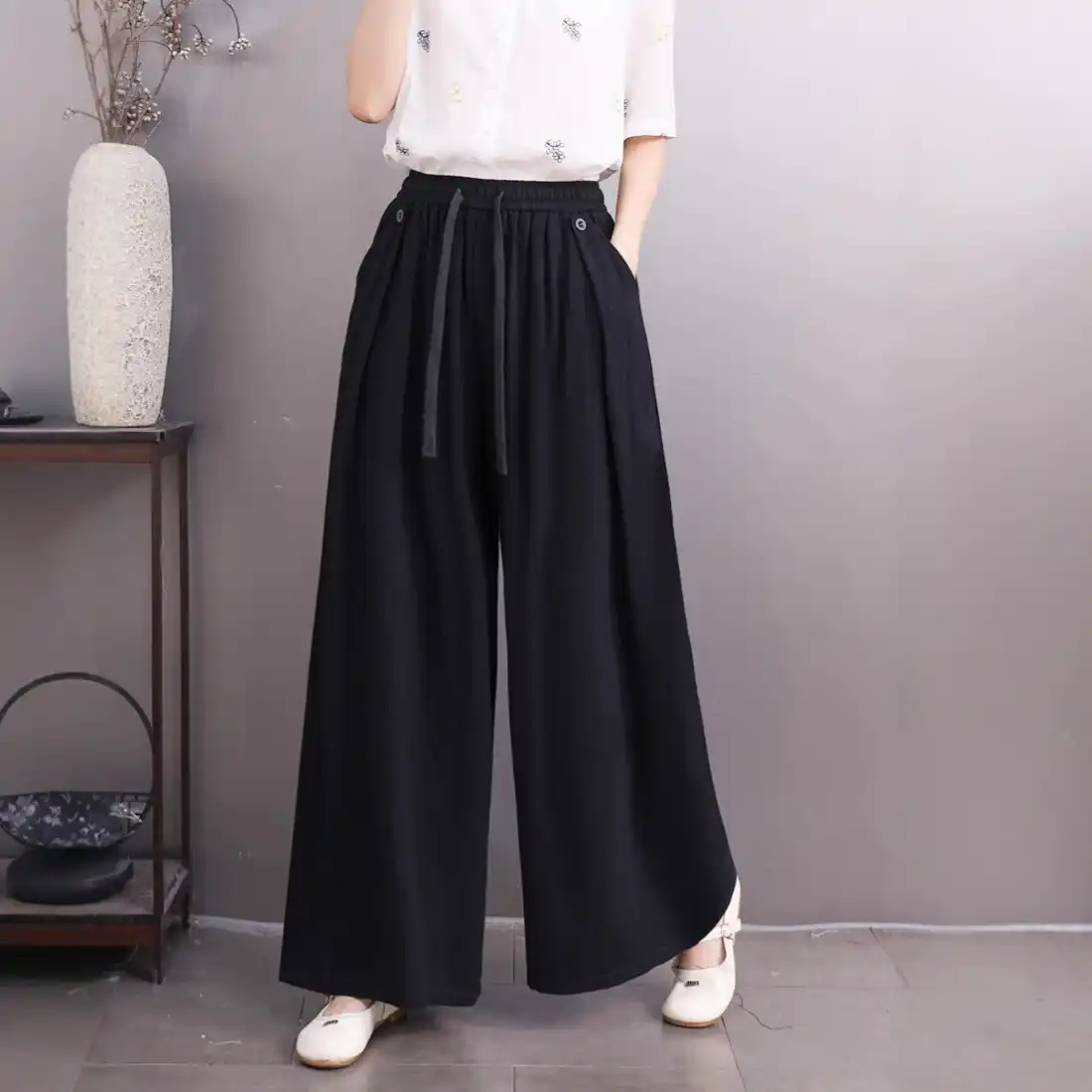- Buddha Bodhis Woman wearing beige linen wide leg trousers for zen office style