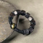 The Dragon's Eye: A Golden Obsidian Ebony Bracelet
