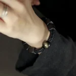 The Dragon's Eye: A Golden Obsidian Ebony Bracelet